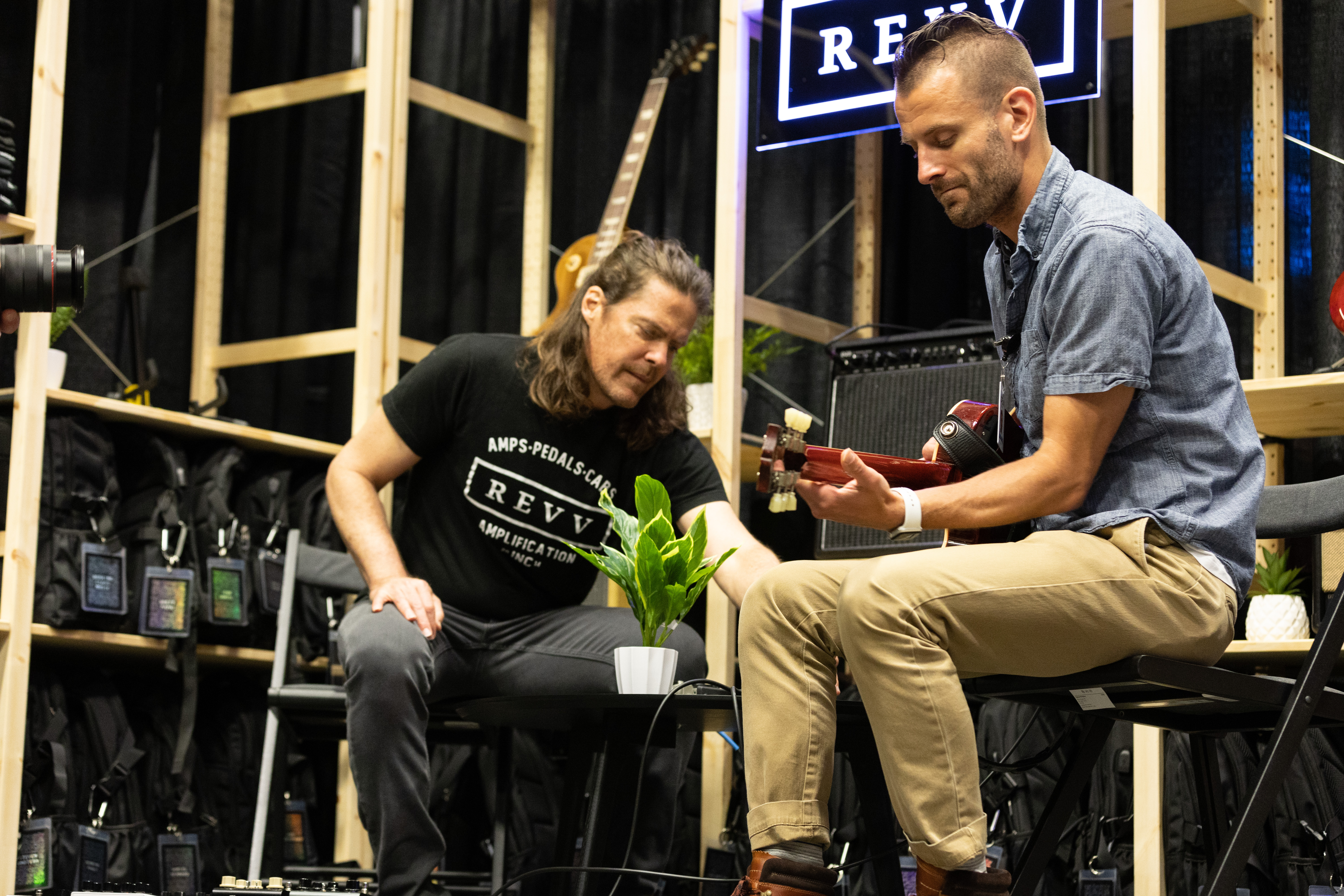 Sweetwater Sales Engineer Ben Stokes talks shop with Shawn Tubbs at the GearFest 2023 REVV booth.